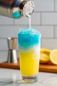 Combine the Blue Curaçao, coconut cream, pineapple juice, and lemon juice in a cocktail shaker and shake well.