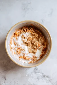 Combine yogurt, grated carrots, and dry ingredients to form a batter