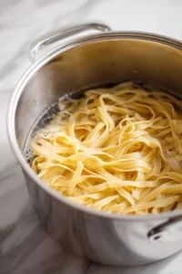 Cook the fettuccine until al dente