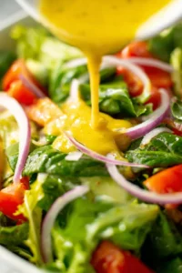 Drizzle dressing over salad and toss to combine