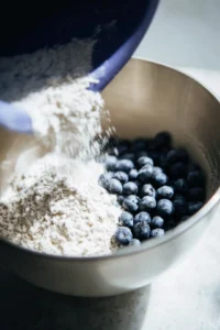 Fold in blueberries and divide batter into pans