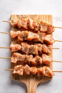 Grill chicken skewers until charred and cooked through