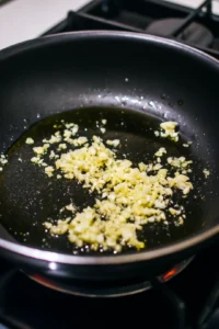 Heat olive oil and sauté garlic in a pan