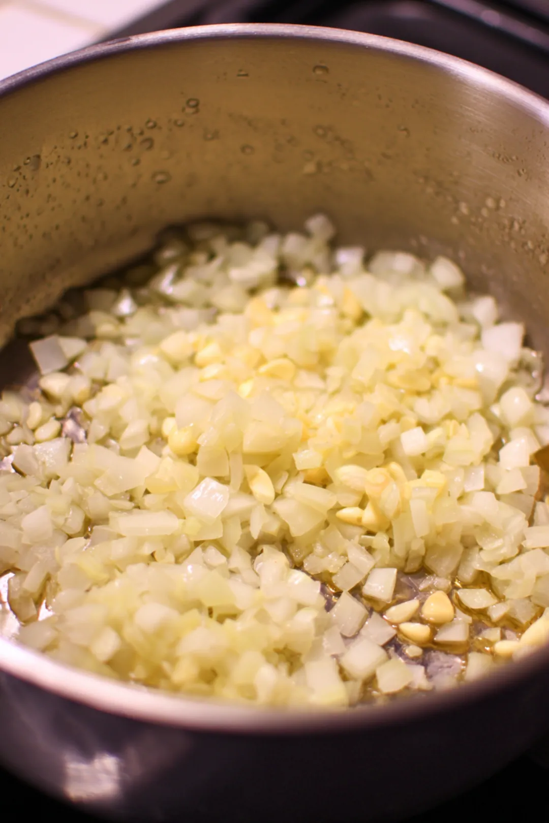 Heat olive oil in a large pot and sauté diced onion until soft