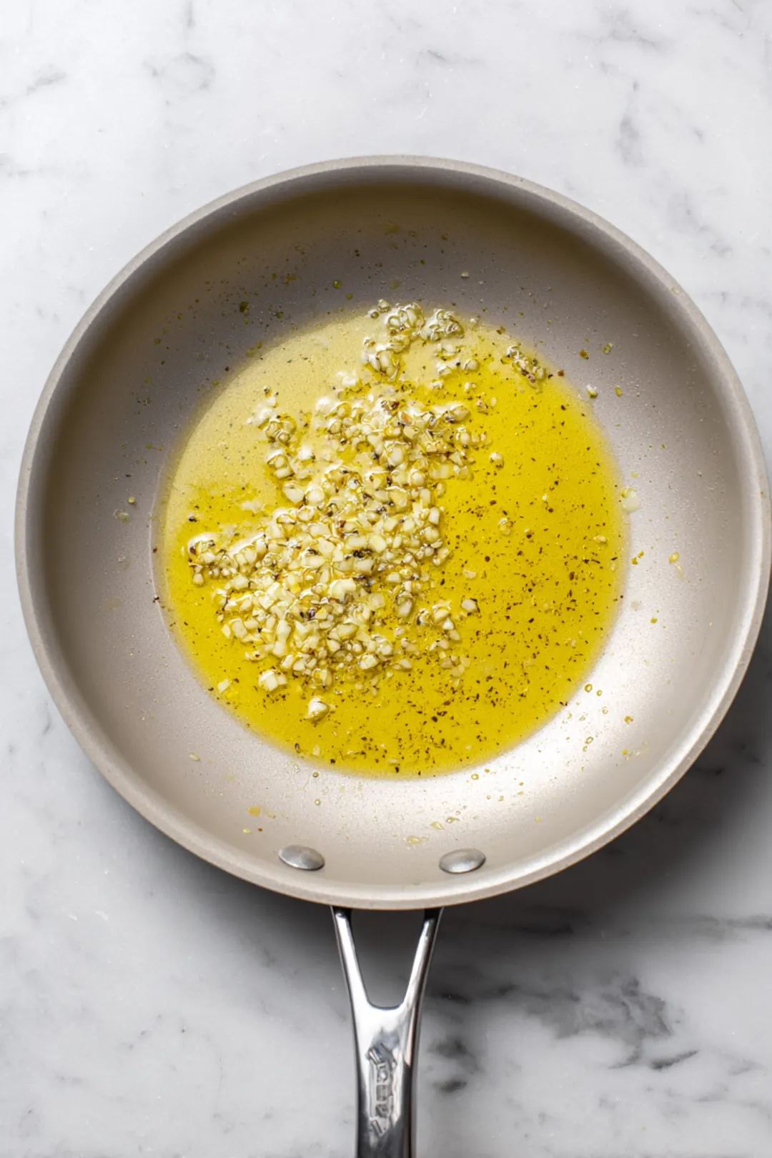 Heat olive oil in a large skillet over medium-high heat and sauté garlic until fragrant