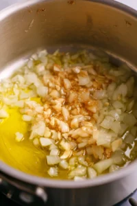 Heat the olive oil and sauté the onion and garlic until translucent