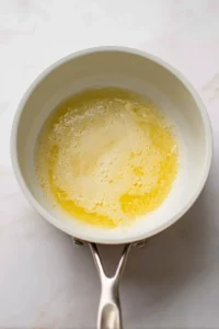 Melt beef tallow in a saucepan over low heat