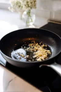 Melt butter and sauté garlic in a pan