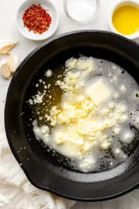 Melt butter in a skillet and sauté garlic