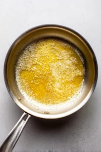 Melt unsalted butter in a saucepan over medium heat until golden brown