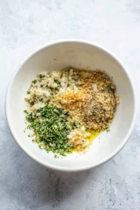 Mix breadcrumbs with onion, garlic, olive oil, spices, lemon juice, and tahini until combined