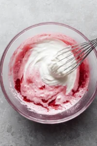 Mix heavy cream with strawberry syrup and simple syrup until combined