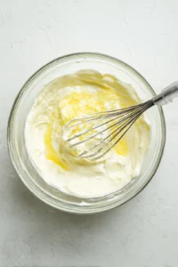 Mix ricotta cheese, lemon juice, and grated parmesan in a bowl to create a creamy sauce