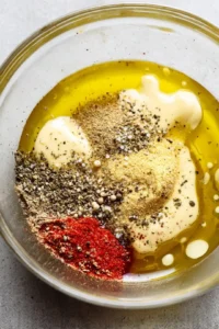 Mix together the dressing ingredients in a large bowl