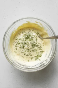 Mix together the mayonnaise, lemon juice, dill, salt, and pepper until smooth