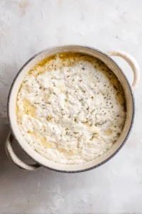 Mix water and sourdough starter with dry ingredients to form soft dough