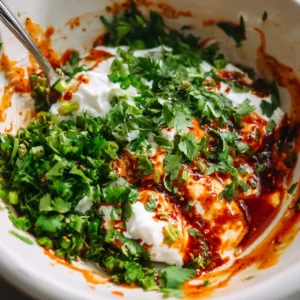 Mix yogurt, cilantro, and chili lime dressing in a bowl