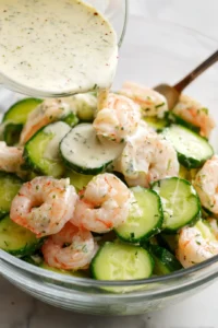 Pour the dressing over the cucumber and shrimp and let flavors meld in the refrigerator
