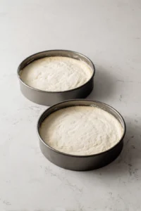 Preheat oven to 350 degrees Fahrenheit and grease and flour cake pans