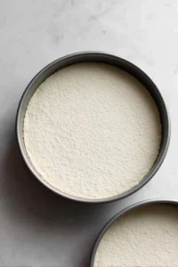 Preheat the oven to 350 degrees Fahrenheit and grease and flour cake pans