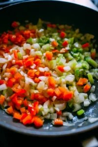Sauté chopped onion and bell pepper in oil until soft