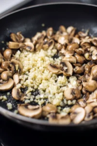 Sauté garlic and mushrooms in olive oil until tender