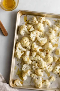 Spread cauliflower on baking sheet and roast until golden brown