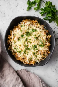 Sprinkle shredded cheese over the dish and cover until melted