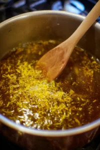 Stir in honey and lemon zest and simmer the mixture