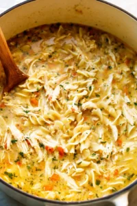 Stir in the shredded chicken, chicken broth, and broken lasagna noodles and simmer until tender