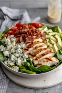Top the salad base with sliced grilled chicken, crumbled bacon and blue cheese for an added protein punch.
