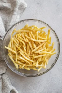 Toss fries with olive oil and Cajun seasoning