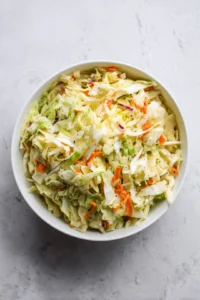 Toss the slaw and let it sit to enhance flavors