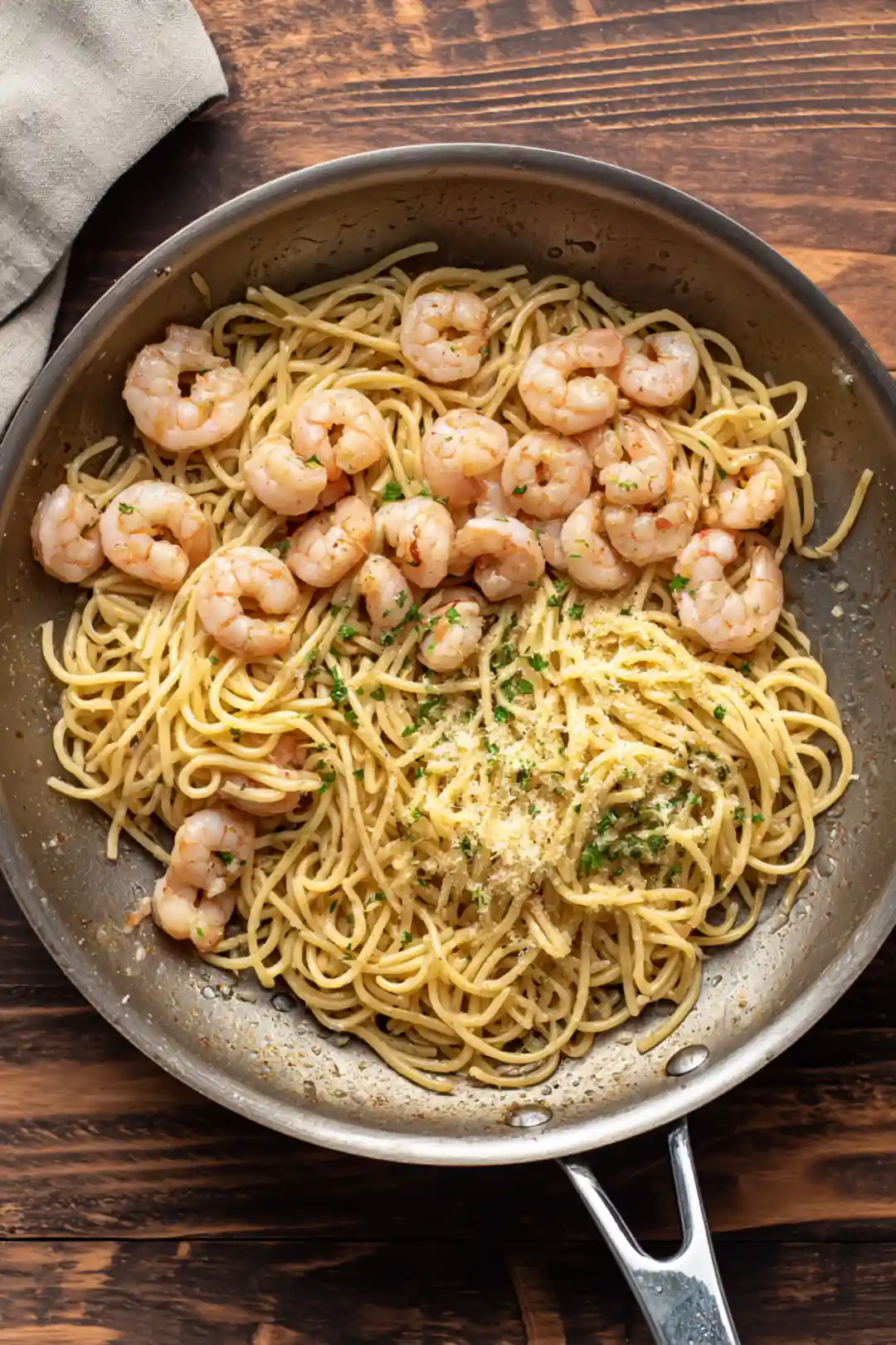 Transfer the cooked pasta and shrimp mixture to a baking dish and sprinkle with cheese, then bake until bubbly and golden