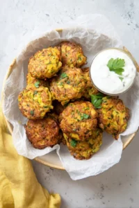 Transfer the fritters to a paper towel-lined plate to absorb excess oil and serve warm with your favorite dipping sauce or fresh herbs