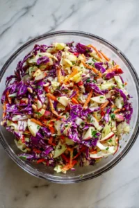 Whisk together apple cider vinegar, olive oil, honey, salt, and black pepper