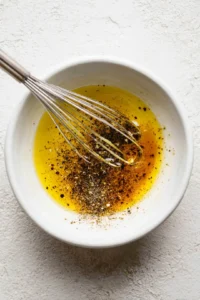 Whisk together olive oil, balsamic vinegar, honey, salt, and black pepper