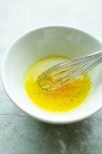 Whisk together olive oil, lemon juice, and honey in a small bowl