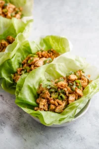 Wrap the chicken mixture in lettuce and slice in half